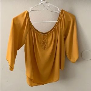 Mustard yellow blouse with criss-cross patterns